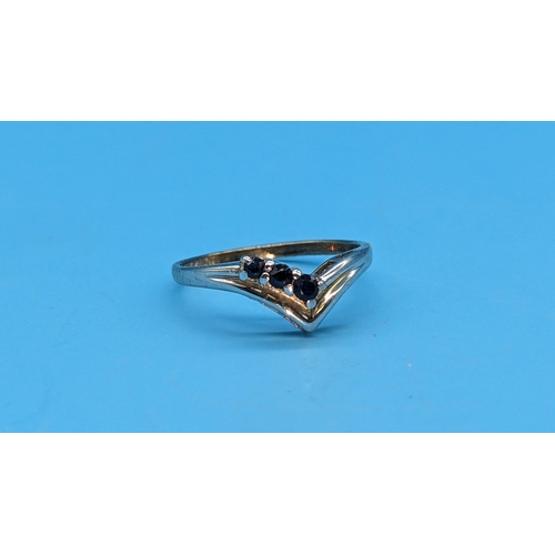 582 - A V Shaped Hallmarked 9ct White Gold Plated Sapphire Ring. Size L/M.