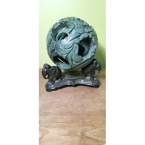 699 - A Chinese Carved Jade Puzzle Ball on Carved  Wooden Stand