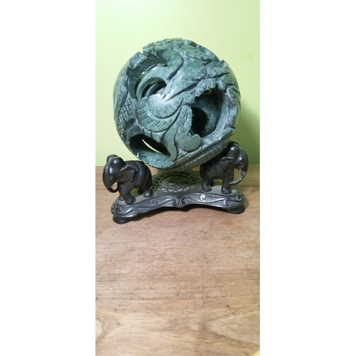 699 - A Chinese Carved Jade Puzzle Ball on Carved  Wooden Stand