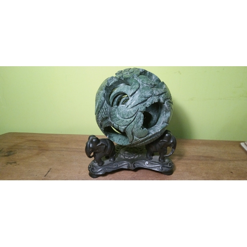 699 - A Chinese Carved Jade Puzzle Ball on Carved  Wooden Stand