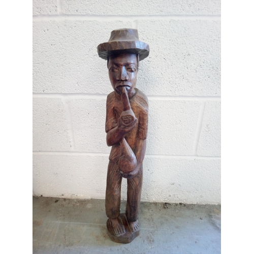 390 - Wooden Carved Ethnic Man Smoking a Pipe. Standing 64cm.