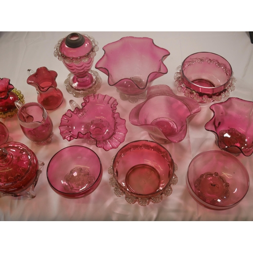 68 - A GROUP OF VICTORIAN CRANBERRY GLASS WARES, the lot including a powder bowl and cover, three jugs, h... 