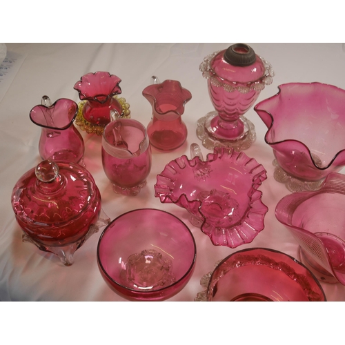 68 - A GROUP OF VICTORIAN CRANBERRY GLASS WARES, the lot including a powder bowl and cover, three jugs, h... 