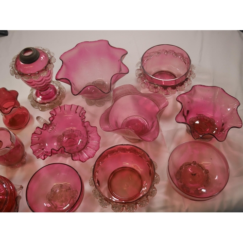 68 - A GROUP OF VICTORIAN CRANBERRY GLASS WARES, the lot including a powder bowl and cover, three jugs, h... 