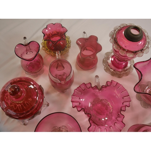 68 - A GROUP OF VICTORIAN CRANBERRY GLASS WARES, the lot including a powder bowl and cover, three jugs, h... 