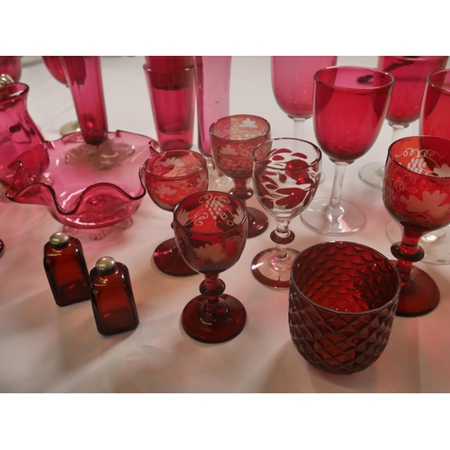 70 - A GROUP OF 19TH CENTURY CRANBERRY GLASS WARES, including two trumpet vases, jugs, bowl and stemmed g... 