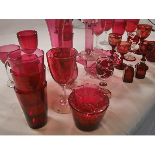 70 - A GROUP OF 19TH CENTURY CRANBERRY GLASS WARES, including two trumpet vases, jugs, bowl and stemmed g... 