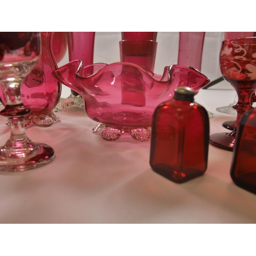 70 - A GROUP OF 19TH CENTURY CRANBERRY GLASS WARES, including two trumpet vases, jugs, bowl and stemmed g... 