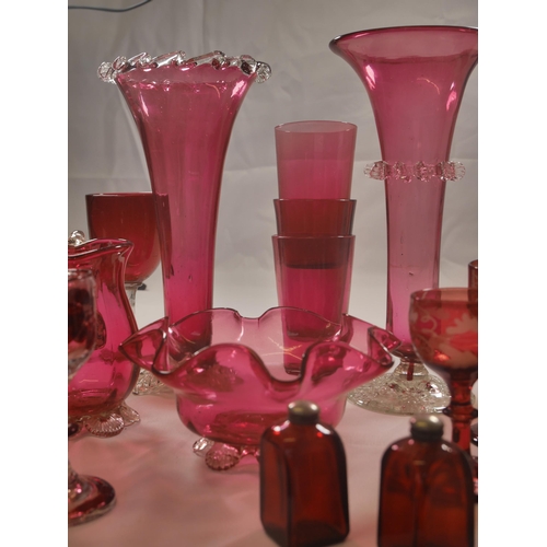 70 - A GROUP OF 19TH CENTURY CRANBERRY GLASS WARES, including two trumpet vases, jugs, bowl and stemmed g... 