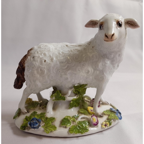 82 - A MID 18TH CENTURY MEISSEN FIGURE OF A EWE, on an oblong tree trunk mound base, with applied branche... 