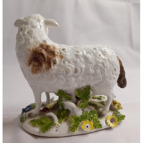 82 - A MID 18TH CENTURY MEISSEN FIGURE OF A EWE, on an oblong tree trunk mound base, with applied branche... 