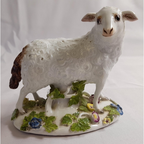 82 - A MID 18TH CENTURY MEISSEN FIGURE OF A EWE, on an oblong tree trunk mound base, with applied branche... 