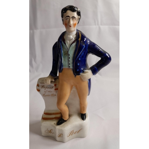 84 - A STAFFORDSHIRE MID 19TH CENTURY FIGURE OF SIR ROBERT PEEL, modelled with hand on hip, the other han... 