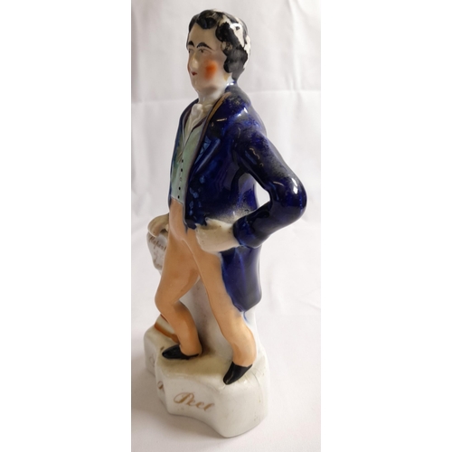 84 - A STAFFORDSHIRE MID 19TH CENTURY FIGURE OF SIR ROBERT PEEL, modelled with hand on hip, the other han... 