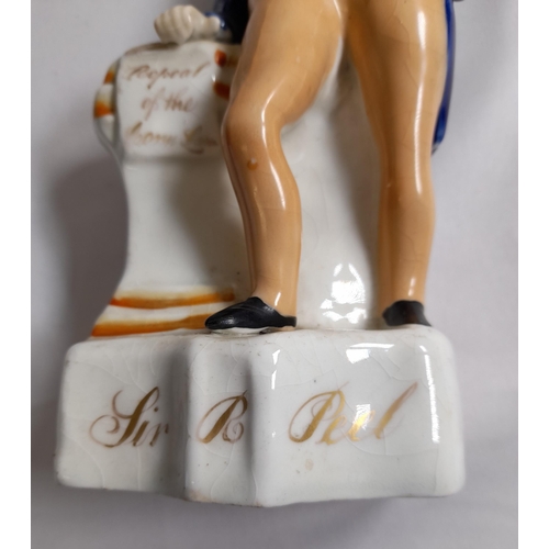 84 - A STAFFORDSHIRE MID 19TH CENTURY FIGURE OF SIR ROBERT PEEL, modelled with hand on hip, the other han... 