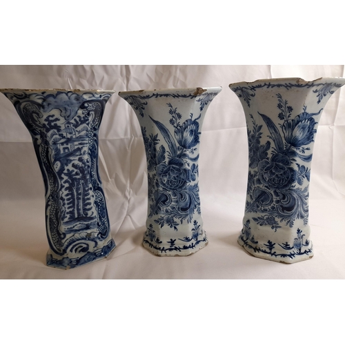 87 - A PAIR OF DELFT 18TH CENTURY OCTAGONAL BEAKER VASES, with flared mouths, the sides painted with flow... 