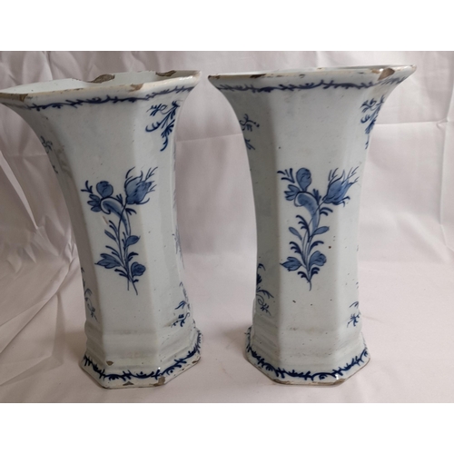 87 - A PAIR OF DELFT 18TH CENTURY OCTAGONAL BEAKER VASES, with flared mouths, the sides painted with flow... 