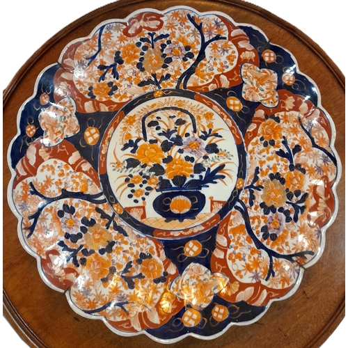 91 - A PAIR OF JAPANESE LOBED IMARI CHARGERS, along with a smaller lobed plate and an octagonal plate, al... 