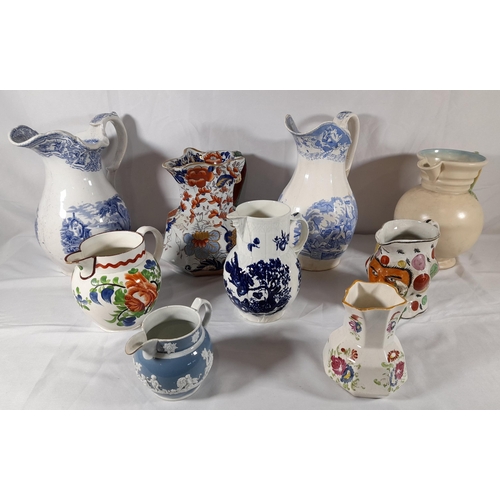 133 - A GROUP OF NINE VARIOUS CERAMIC JUGS, the lot includes a Mason's ironstone jug, a Clarice Cliff Newp... 