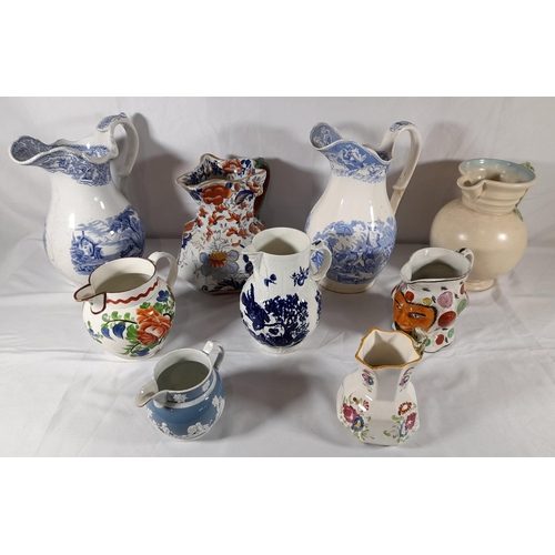 133 - A GROUP OF NINE VARIOUS CERAMIC JUGS, the lot includes a Mason's ironstone jug, a Clarice Cliff Newp... 