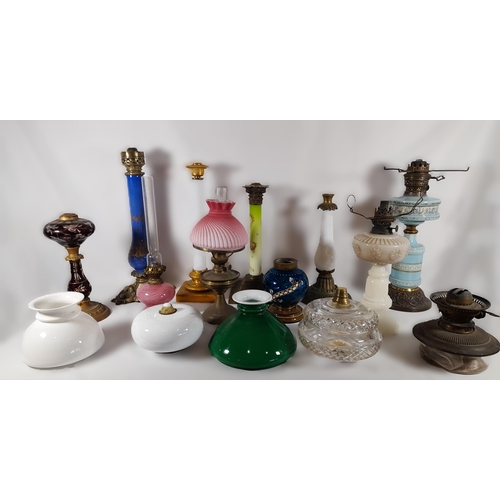 144 - A GROUP OF 19TH CENTURY BRASS AND COLOURED GLASS OIL LAMP BASES, including an attractive green glass...