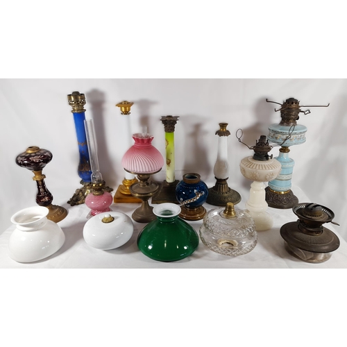 144 - A GROUP OF 19TH CENTURY BRASS AND COLOURED GLASS OIL LAMP BASES, including an attractive green glass... 