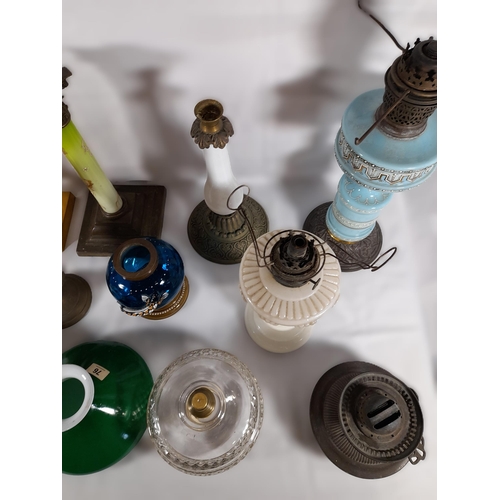 144 - A GROUP OF 19TH CENTURY BRASS AND COLOURED GLASS OIL LAMP BASES, including an attractive green glass... 