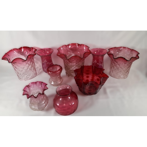 158 - A GROUP OF NINE CRANBERRY TINGED GLASS LAMP SHADES, various styles and sizes, some with etched decor... 