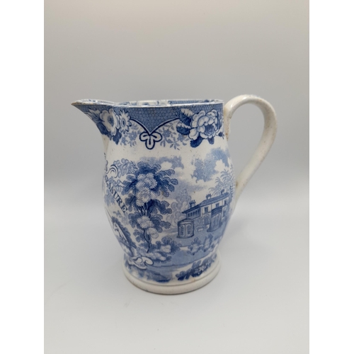 164 - AN EARLY VICTORIAN BLUE & WHITE IMPERIAL MEASURE JUG, the transfer printed sides decorated with buco... 