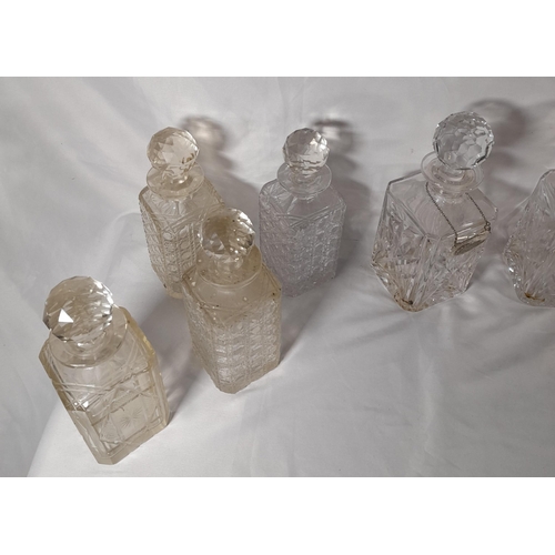 165 - A GROUP OF TWELVE VINTAGE CUT GLASS DECANTERS, all of square form with stoppers
25 cm high max