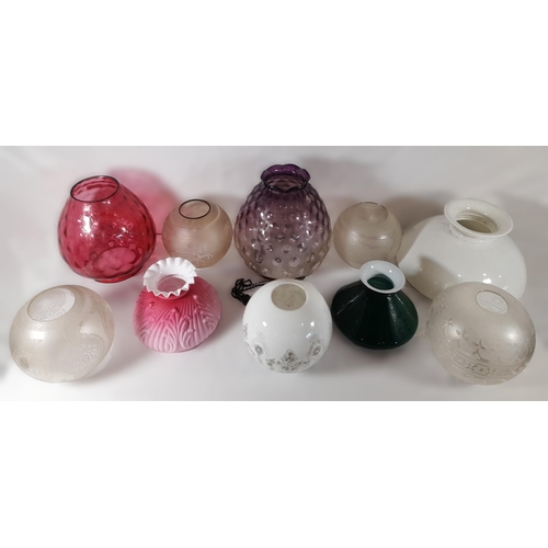 174 - A MIXED GROUP OF TEN VINTAGE GLASS OIL LAMP SHADES, various styles and colours including a cranberry... 