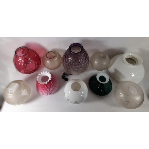 174 - A MIXED GROUP OF TEN VINTAGE GLASS OIL LAMP SHADES, various styles and colours including a cranberry... 