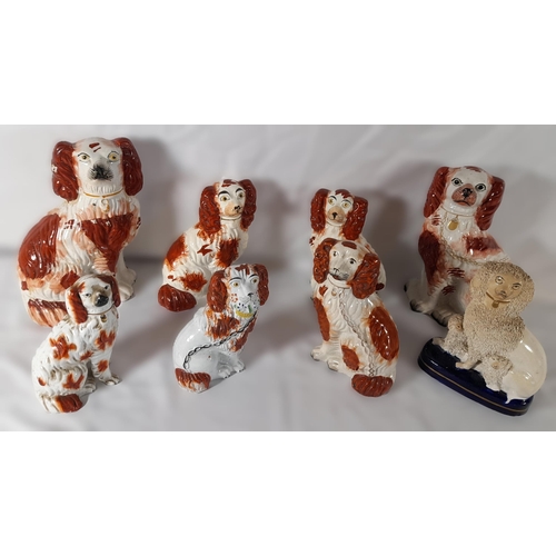 179 - A PAIR OF 19TH CENTURY STAFFORDSHIRE SPANIEL MODELS, along with six other Staffordshire spaniel mode... 