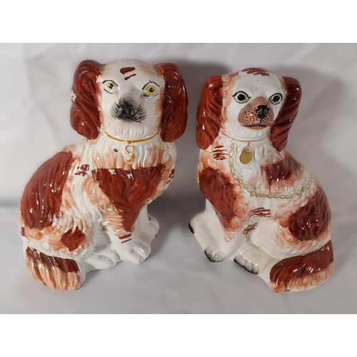 179 - A PAIR OF 19TH CENTURY STAFFORDSHIRE SPANIEL MODELS, along with six other Staffordshire spaniel mode... 