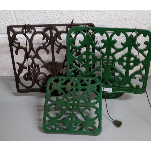 661 - 2 Cast Iron Book Stands and A Trivet.