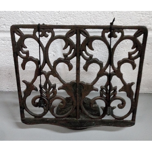 661 - 2 Cast Iron Book Stands and A Trivet.