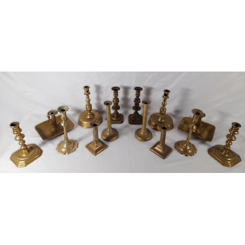 189 - SEVEN PAIRS OF 19TH CENTURY BRASS CANDLESTICKS, including a pair on domed circular feet and a pair o... 