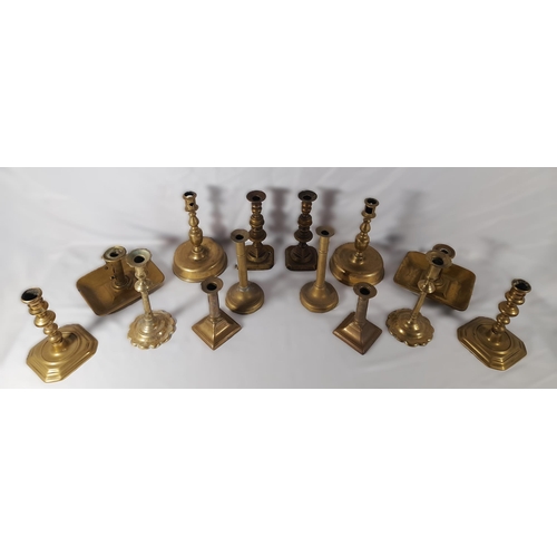 189 - SEVEN PAIRS OF 19TH CENTURY BRASS CANDLESTICKS, including a pair on domed circular feet and a pair o... 