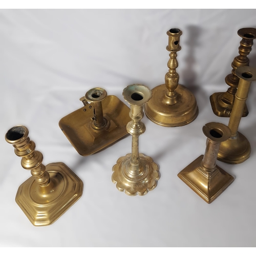 189 - SEVEN PAIRS OF 19TH CENTURY BRASS CANDLESTICKS, including a pair on domed circular feet and a pair o... 