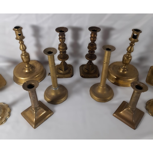 189 - SEVEN PAIRS OF 19TH CENTURY BRASS CANDLESTICKS, including a pair on domed circular feet and a pair o... 