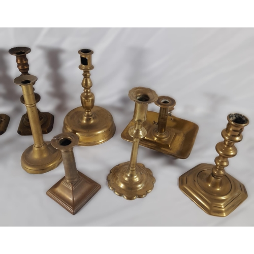 189 - SEVEN PAIRS OF 19TH CENTURY BRASS CANDLESTICKS, including a pair on domed circular feet and a pair o... 