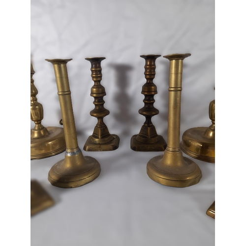 189 - SEVEN PAIRS OF 19TH CENTURY BRASS CANDLESTICKS, including a pair on domed circular feet and a pair o... 