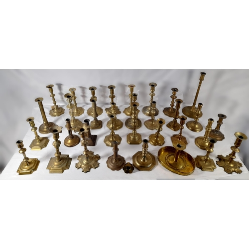 190 - A MIXED COLLECTION OF THIRTY THREE 18TH & 19TH CENTURY BRASS CANDLESTICKS, various shapes and styles... 