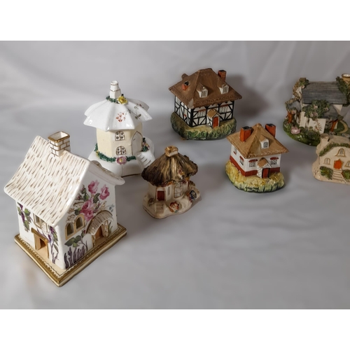 206 - A GROUP OF ELEVEN 19TH CENTURY PASTEL BURNERS, modelled as cottages and houses, various sizes
14.5 c... 