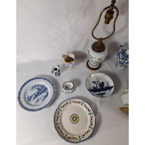 213 - A GROUP OF 18TH/19TH CENTURY FAIENCE POTTERY WARES, including Dutch Delft plates, a polychrome balus... 