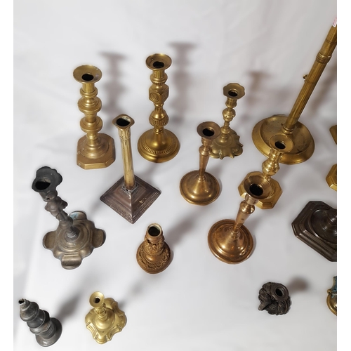 216 - SIX PAIRS OF 19TH CENTURY BRASS CANDLESTICKS, and a floral decorated gilt metal pair of candlesticks... 