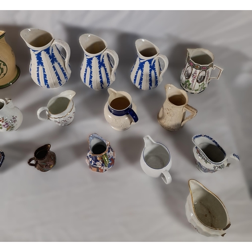 242 - A GRADUATED SET OF VICTORIAN PARIAN WARE JUGS AND A MIXED GROUP OF JUGS AND PITCHERS, including a Du... 