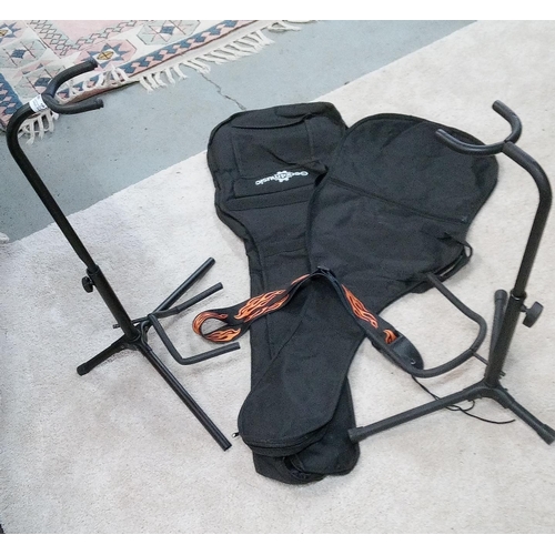 354 - 2 Guitar Stands, 2 Guitar Soft Cases and a Guitar Strap.