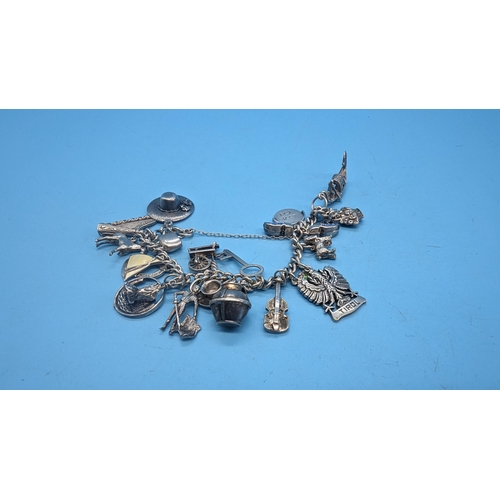 434 - A Silver Charm Bracelet and 20 Charms -55gms.