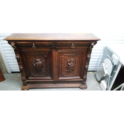 792B - An Oak Heavily Carved Buffet Sideboard with Fish and Foul Motifs.